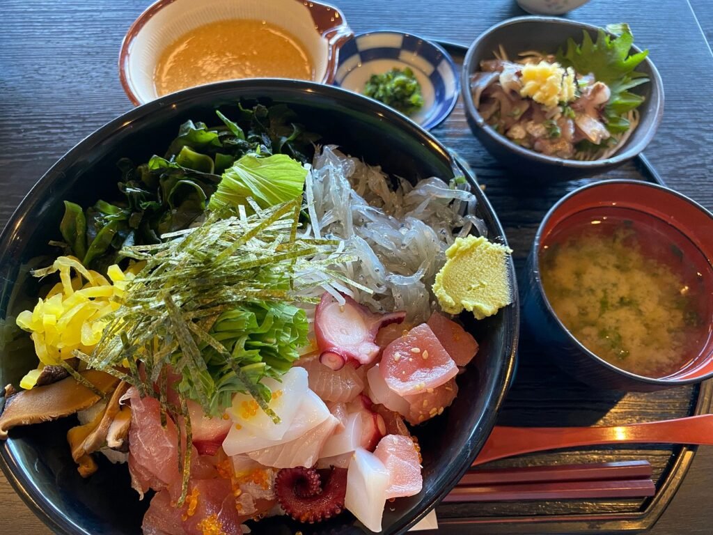 What to Do in Enoshima (2026): Best Sights, Sunset Views & Hidden Gems 25 Makanai Donburi, a small bowl of seared horse mackerel, and shirasu tempura.