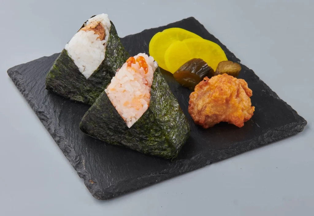Where To Eat At Tokyo Station (2026): 20 Best Lunch Spots 15 Two sushi rice triangles with sides
