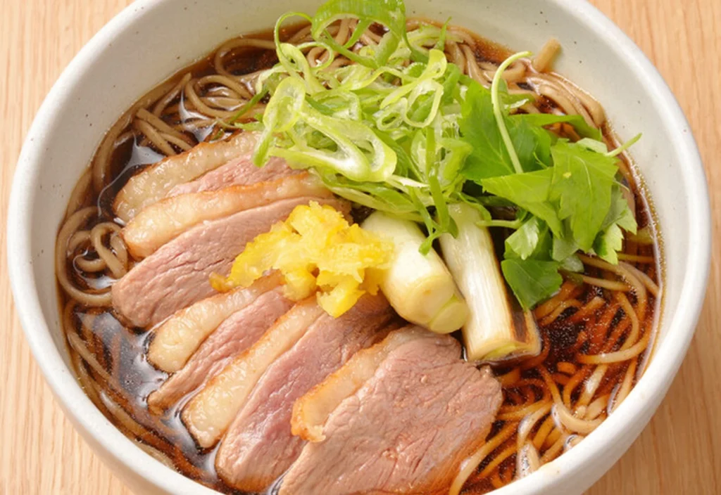 Where To Eat At Tokyo Station (2026): 20 Best Lunch Spots 12 Bowl of soba with sliced meat