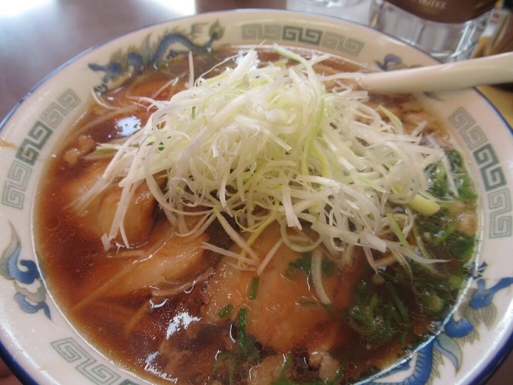 What To Do In Onomichi (2026): 30 Great Sightseeing Spots, Cafes & Parks 29 Bowl of Onomichi ramen at Onomichi Ramen Ichibankan with flat noodles and rich soy sauce broth