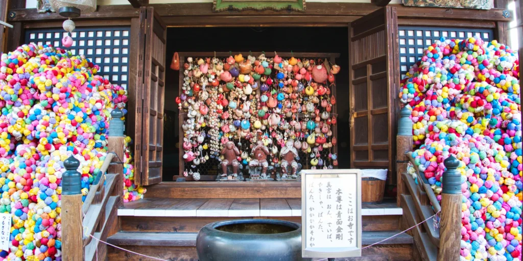 What to Do in Gion Kyoto in 2026: Beautiful Streets, Shrines and Local Experiences 31 Colorful kukuri-zaru charms hanging at Yasaka Koshindo Temple in Kyoto