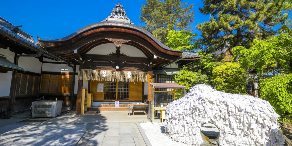 What to Do in Gion Kyoto in 2026: Beautiful Streets, Shrines and Local Experiences 22 Prayer monument covered with paper wishes at Yasui Konpira Shrine in Kyoto