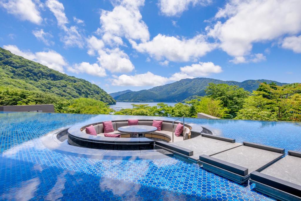 Water terrace at Hakone Ashinoko Hanaori with circular seating and panoramic views of Lake Ashi and mountains