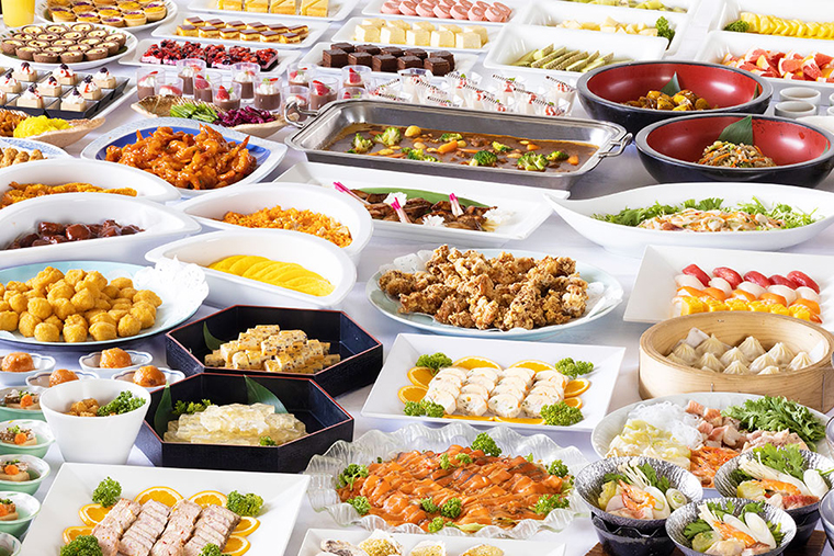 Buffet spread at Hotel Okada with sushi, seafood, hot dishes, fruit, and desserts
