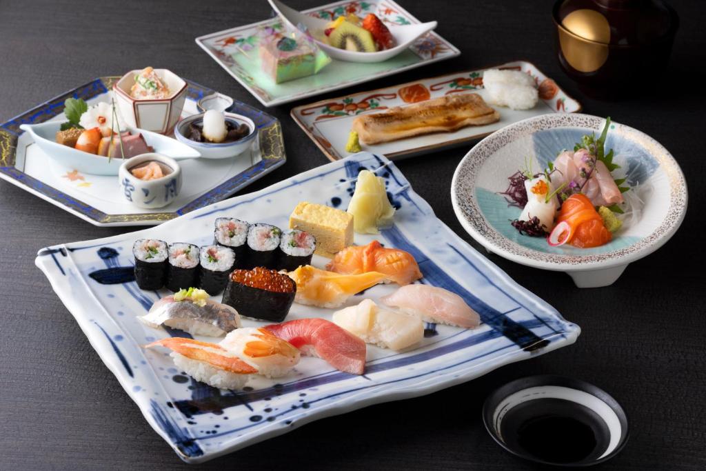 Japanese dinner set at Yumoto Fujiya Hotel with sushi, sashimi, grilled fish, and dessert