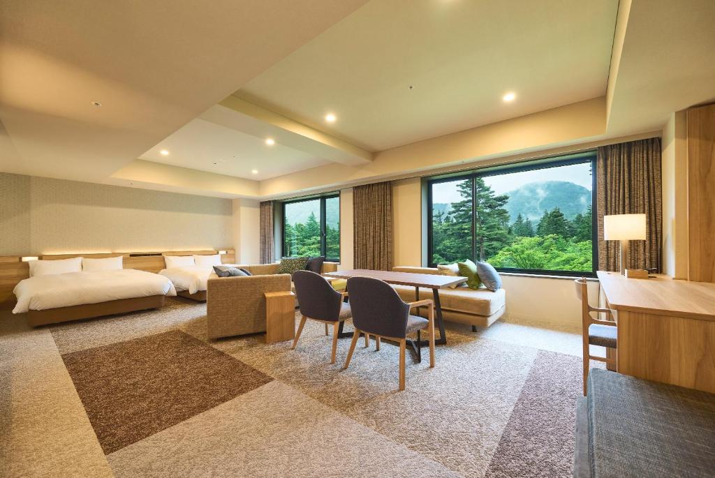 Spacious family room at Hakone Hotel Kowakien with twin beds, sofa seating, and mountain views