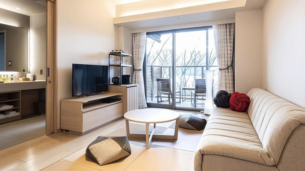 Lakeside guest room at Hakone Ashinoko Hanaori with sofa seating, television, and a private balcony