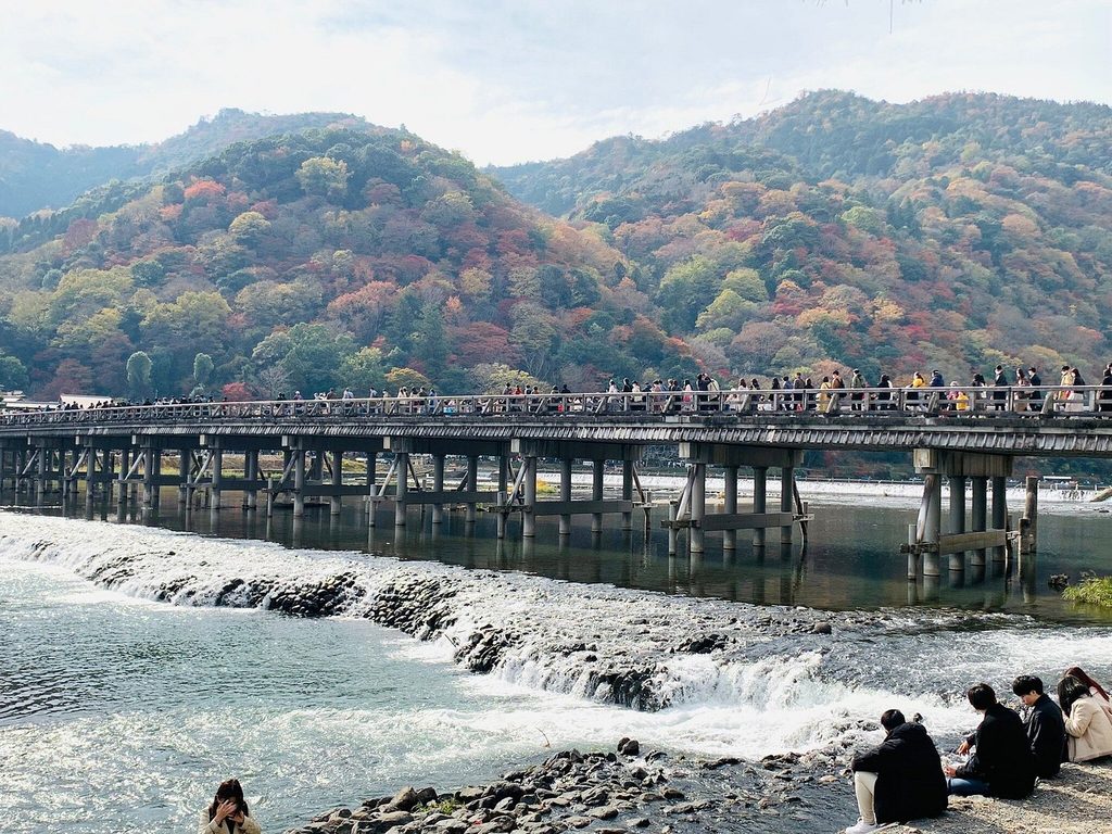 Togetsukyo Bridge crossing the river beneath forested hills in Arashiyama