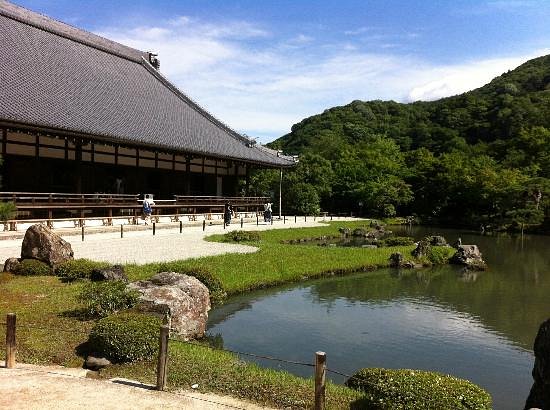 Tenryu-ji Temple garden in Arashiyama with a pond and surrounding greenery