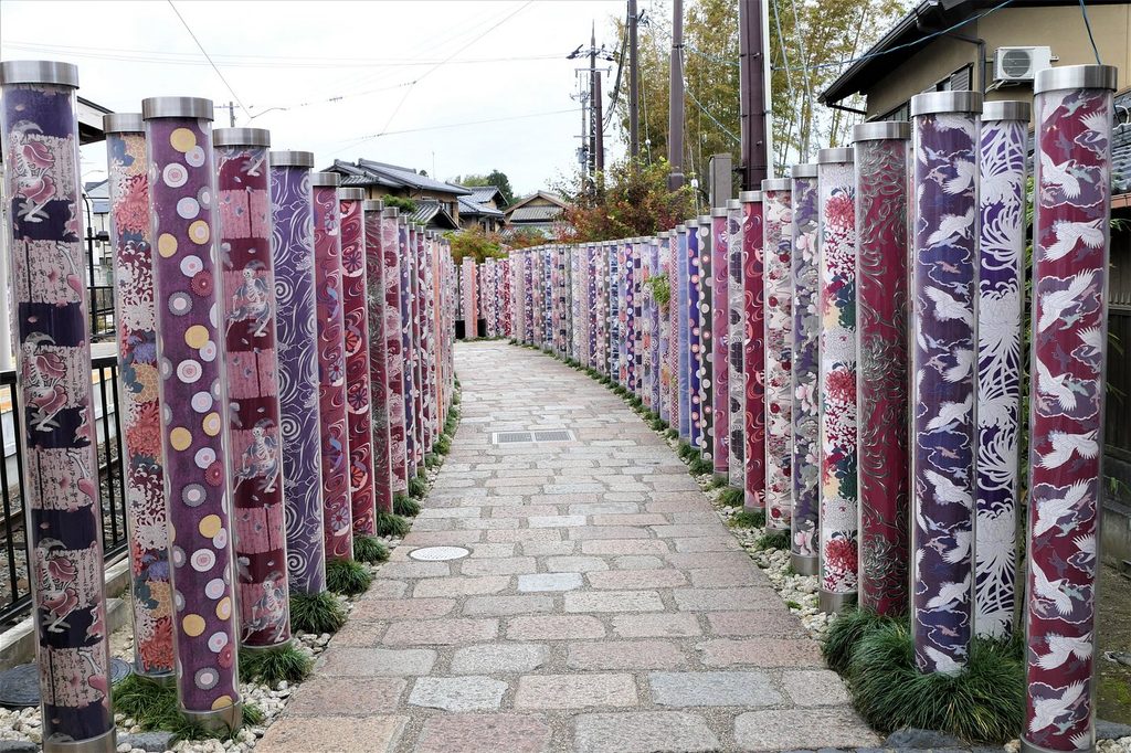 Colorful kimono-patterned pillars at Kimono Forest beside Randen Arashiyama Station