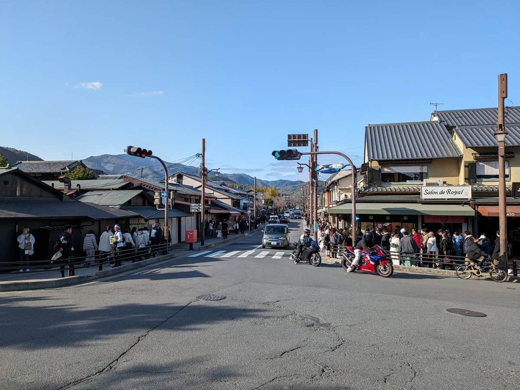 Nagatsuji-dori shopping street in Arashiyama with shops and pedestrians